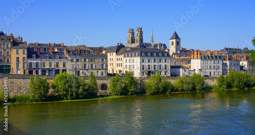 Bell towers of the Orl  ans Cathedral of Sainte Croix   Holy Cross   peeking above apartment buildings on the Loire riverside  in the French department of Loiret in the Center of France