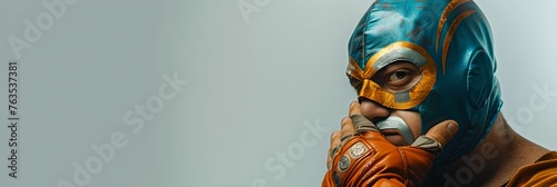 Luchador in mask on gray background. Lucha Libre wrestling mask. Cinco De Mayo holiday, celebration. Mexican culture concept. Design for banner, header with copy space photo