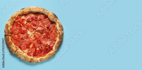 Delicious pepperoni pizza on light blue background with space for text, top view