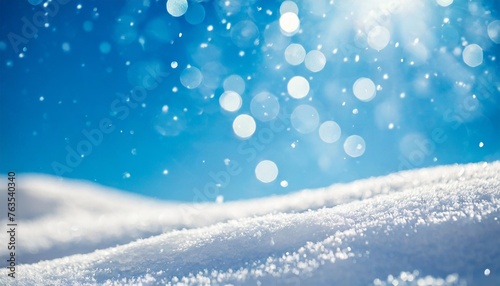 winter snow background with snowdrifts with beautiful light and snow flakes on the blue sky beautiful bokeh circles banner format copy space © Charlotte