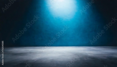 empty dark blue studio background and grey floor concrete perspective with blue soft light well editing floor display product and text present on wall room empty free space black cement backdrop photo