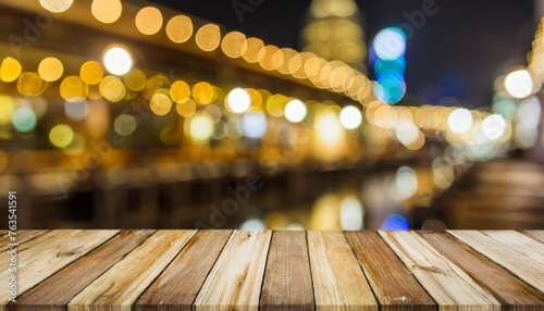 top of wood table with light of blur pub or bar in the dark night background