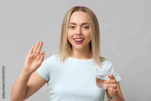 Young woman with vitamin A ...