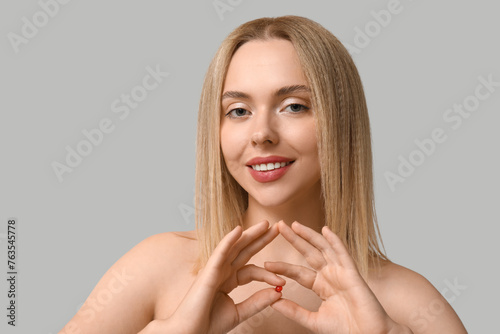 Young woman with vitamin A ...