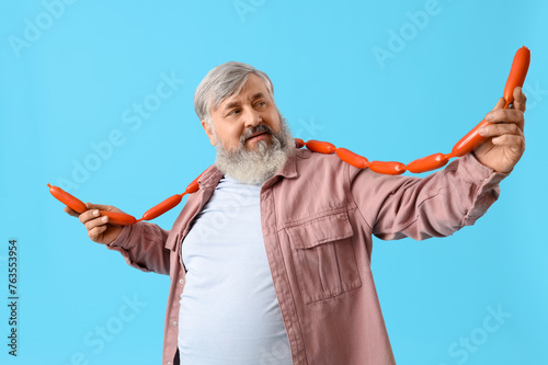 Mature man with tasty sausa...