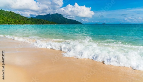 beach wave water in the tropical summer beach with sandy beach background © Kari