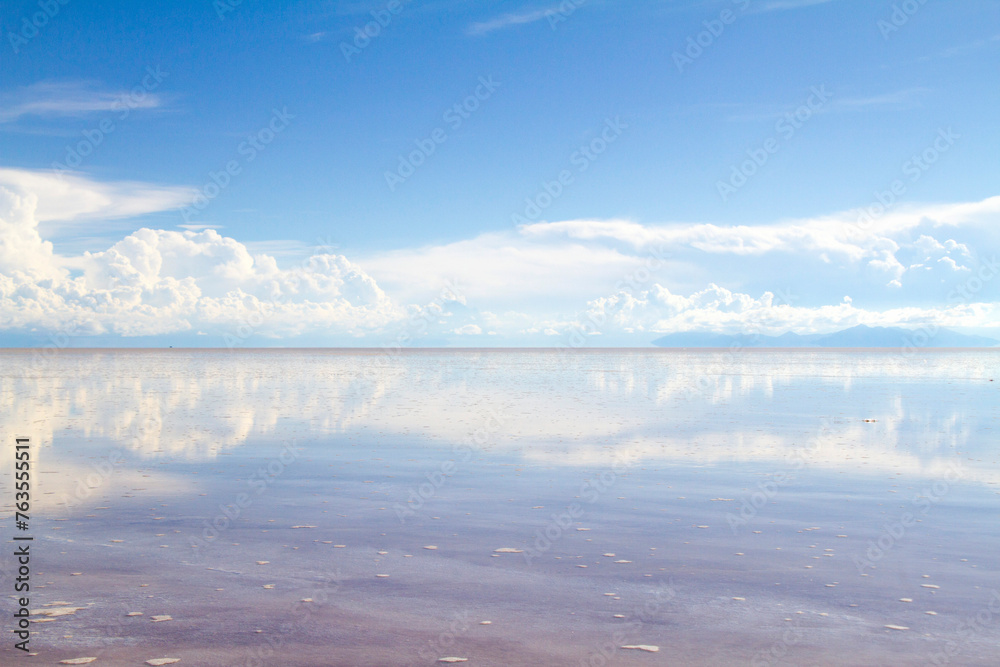 Obraz premium Cielo azul con nubes reflejo natural en el salar de Uyuni Bolivia.