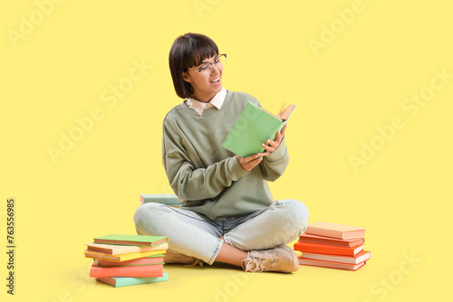 Young woman with books sitt...
