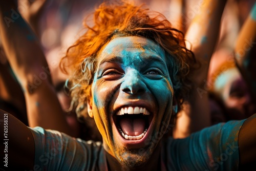 Vibrant holi festival celebration with large crowd joyfully covered in colorful paints in india