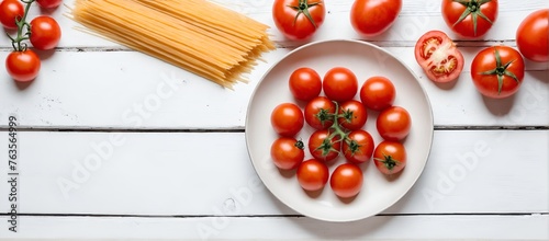 Tomatoes and spaghetti on white wooden table, pasta ingredients