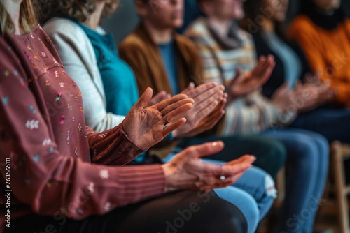 A group of people sat in a circle during a therapy session, clapping their hands together in closeup Generative AI photo