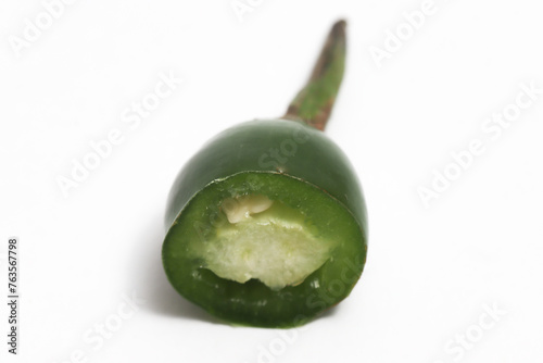 Close-up sliced green hot chili pepper isolated on white background clipping path