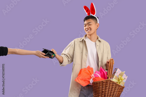 Young Asian man in bunny ea...