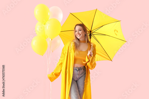Young woman in raincoat wit...