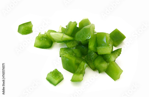 Sliced green bell pepper in a bowl on white background