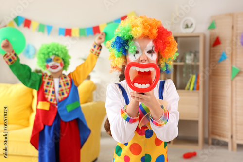 Funny little girl in clown ...