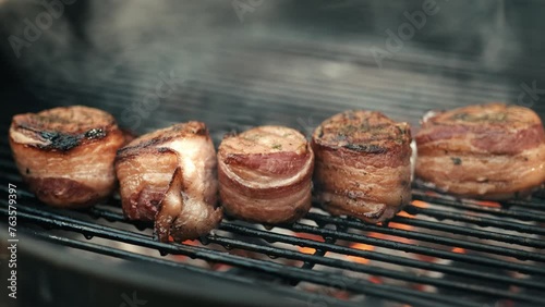 Bacon wrapped pork tenderloin on a barbecue grill  photo