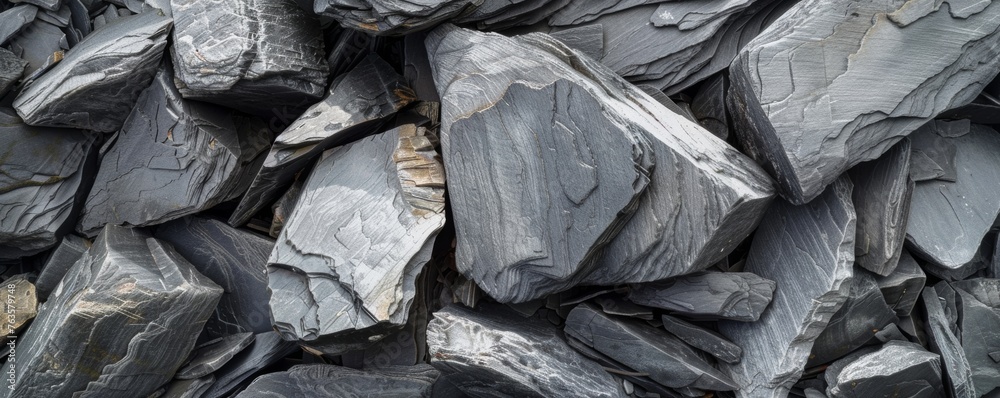 Panoramic shot of natural slate stones piled together forming a textured surface