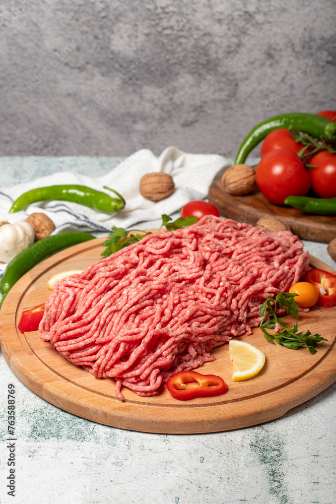 Ground beef. Raw ground beef or minced meat on wood serving board. Close up Ground beef. Raw ground beef or minced meat on wood serving board. Close up