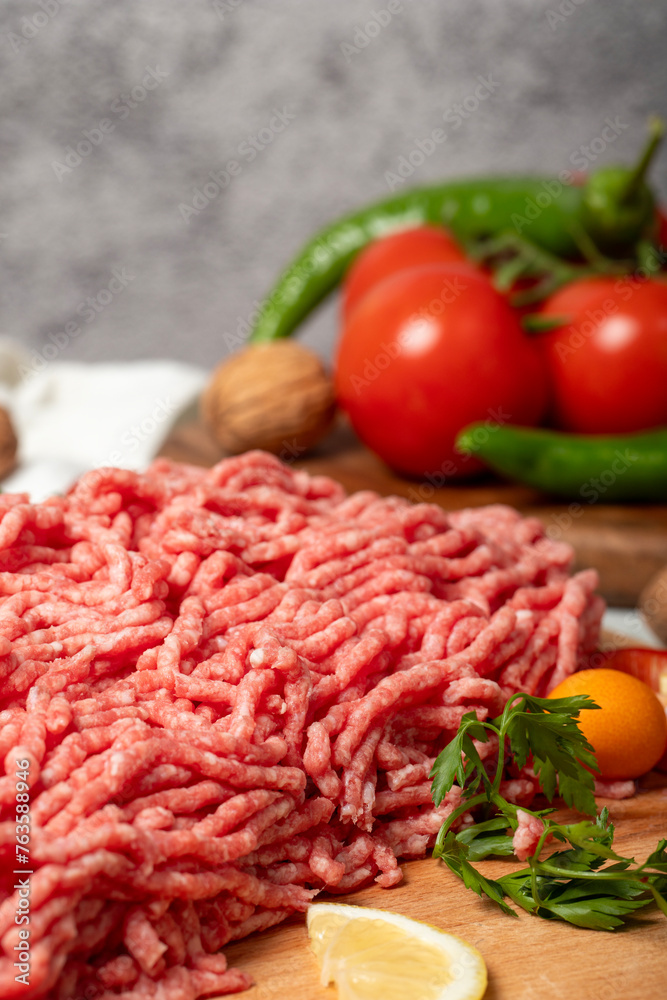Ground beef. Raw ground beef or minced meat on wood serving board. Close up Ground beef. Raw ground beef or minced meat on wood serving board. Close up