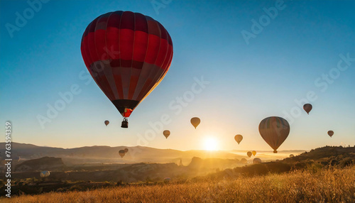 beautiful inspirational sunrise landscape with hot air balloons in sky, nature travel destination, scenic view banner background © Louis