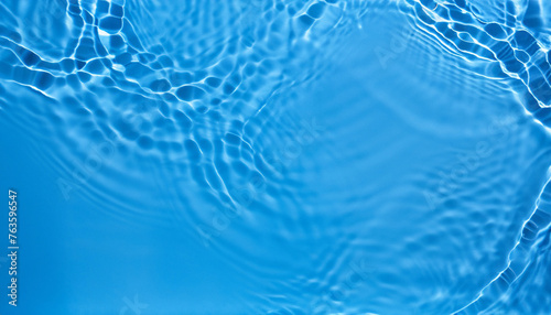 Blue Abstract background texture with water ripples and waves. Copy space. Top view flat lay
