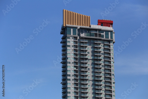 Top of a tall building with a blue sky background at daytime.