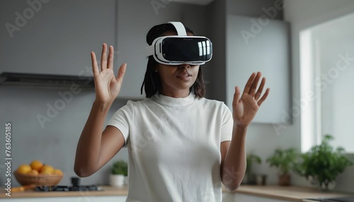 woman in white augmented virtual reality glasses gesticulates with her hands while controlling a virtual screen while standing in a modern home kitchen created with generative ai.  photo