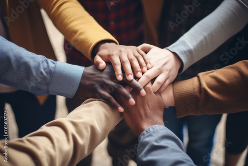 Group of diverse people joining hands. Unity, diversity and collaboration background.