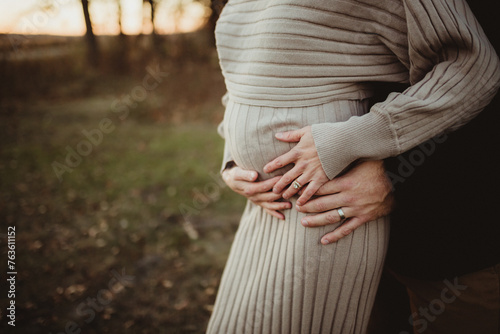mother and father holding belly pregnancy