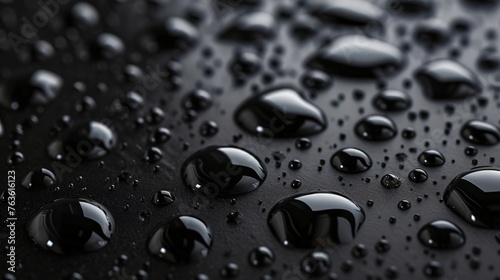 Condensation water drops on a dark glass texture background. Shower or rain droplets, pure aqua blobs. Top view