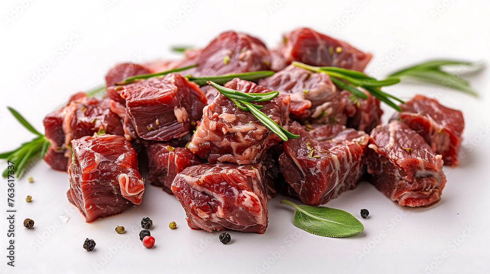 Diced Raw Beef with Rosemary and Peppercorns on White Background Diced Raw Beef with Rosemary and Peppercorns on White Background