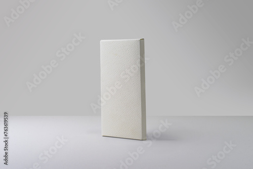 Matte white tall thin chocolate box packaging. Blank cardboard mockup. Textured paper. (real photo) 3D render  (ID: 763619539)