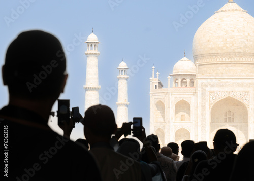 Photography Silhouette of Tourists taking photos with phones at main entrance of Taj Mahal