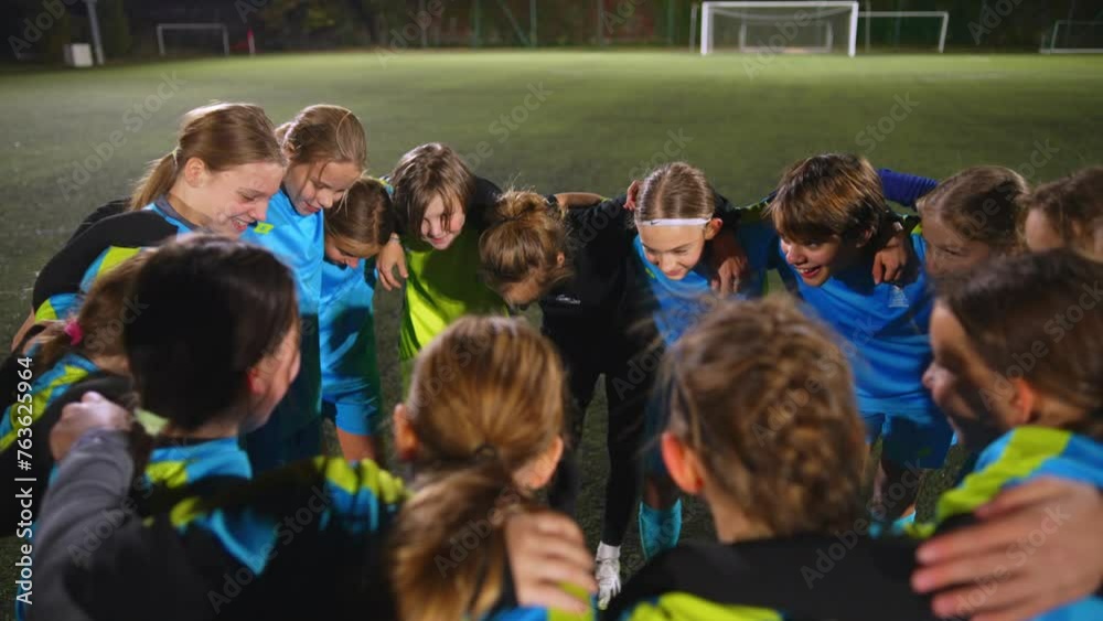 high angle view of little girls standing in a circle and talking about the strategy before match. High quality 4k footage