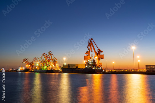 Gantry crane and cargo ship in the evening
