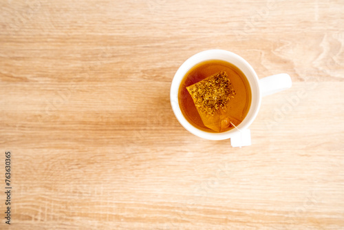 A mug of tea on a wooden table, sun, warm, cold. High quality photo