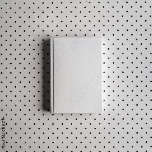 Blank notebook. Hardcover book. Matte white. Clean book mockup. Textured paper. (real photo) 3D render dots in background. From above.  (ID: 763632790)