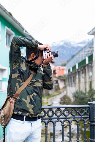 In Asturias, a young traveler, camera in hand, explores, immortalizes vibrant Cabrales. photo