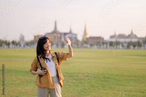 A Traveler Asian woman in her 30s exploring Wat Pra Kaew. From stunning architecture to friendly locals, she cherishes every moment, capturing it all in her heart and camera for years to come.