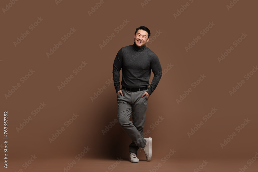 Full length portrait of happy man on brown background Full length portrait of happy man on brown background