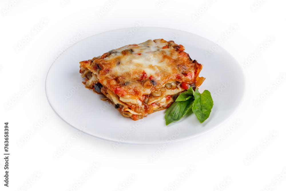 plate of lasagna with green basil on white background plate of lasagna with green basil on white background