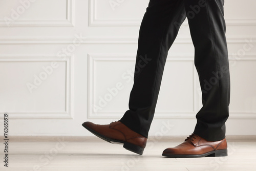 Businessman in elegant leather shoes indoors, closeup. Space for text