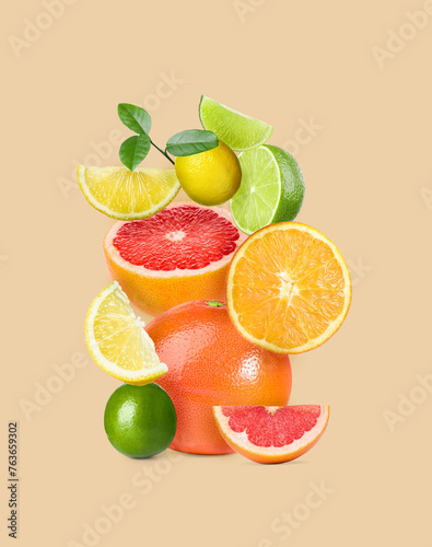 Stack of different citrus fruits on beige background