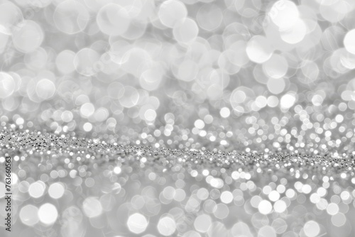 Sparkling silver glitter with a soft bokeh effect creating a luxurious and festive background.