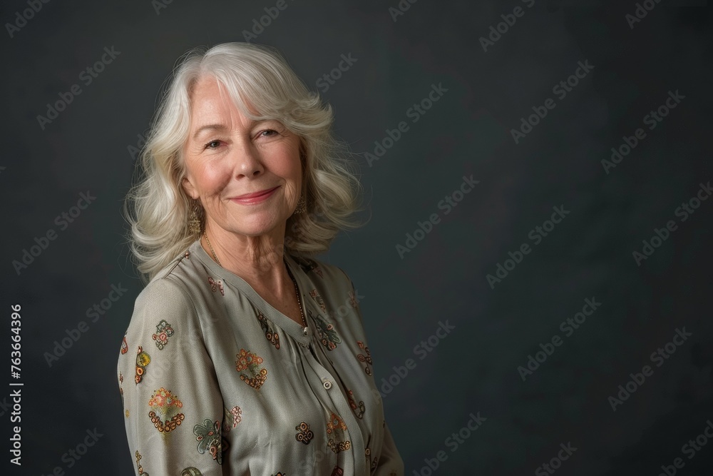 A woman with long white hair is smiling for the camera