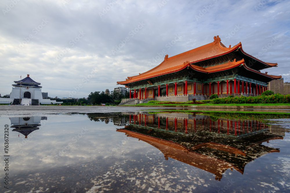 The Chiang Kai-shek Memorial Hall and National Theater with their reflections on a shallow pond at the Liberty Square in Taipei, Taiwan. The square is a very popular tour spot for foreigners.