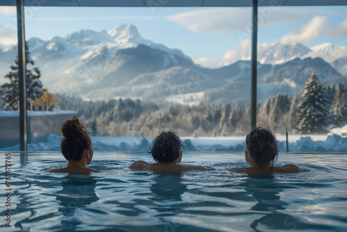 friends having fun in modern thermal baths, tatra mountains in the background