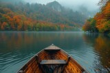 A wooden boat glides across the calm waters of a lake, framed by lush trees in a picturesque natural landscape surrounded by mountains in the ecoregion