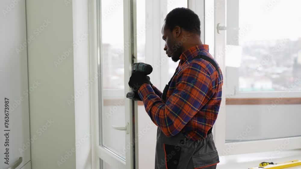 Worker installing and checking window in the house Worker installing and checking window in the house